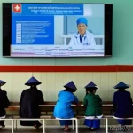 보건학과 국영병원 vs 사립병원 - **Prompt:** "A bustling public hospital waiting room in Vietnam. Elderly Vietnamese patients, some w...